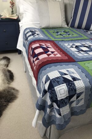 Cotswold Knit Burford Patchwork Blanket on a Bed - As featured in Red Magazine 150 Great Gifts from Small Brands