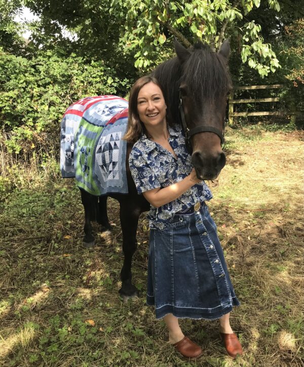 Anna & Ted wearing a Cotswold Knit Burford Patchwork Blanket - As featured in Red Magazine 150 Great Gifts from Small Brands